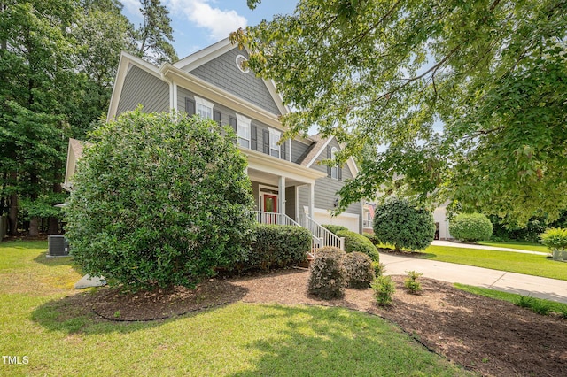 1230 Golden Bluff Ln, Fuquay Varina, NC 27526 - view of front of house featuring a porch, driveway, a front lawn, and central air condition unit