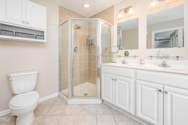 1230 Golden Bluff Ln, Fuquay Varina, NC 27526 - full bathroom with double vanity, a shower stall, toilet, tile patterned flooring, and baseboards