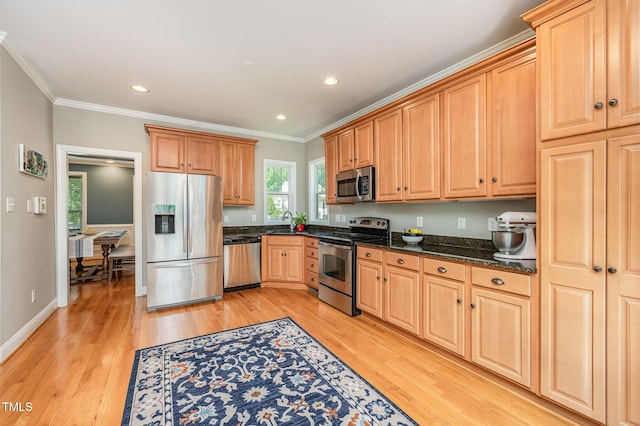 1230 Golden Bluff Ln, Fuquay Varina, NC 27526 - kitchen featuring stainless steel appliances, light wood-type flooring, crown molding, dark stone counters, and recessed lighting