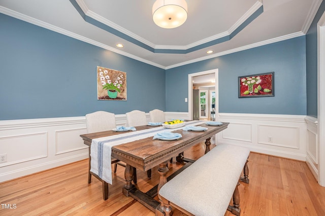 1230 Golden Bluff Ln, Fuquay Varina, NC 27526 - dining room featuring light wood-type flooring, wainscoting, a tray ceiling, crown molding, and recessed lighting