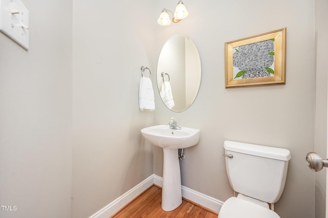 1230 Golden Bluff Ln, Fuquay Varina, NC 27526 - half bath with baseboards, toilet, wood finished floors, and a sink