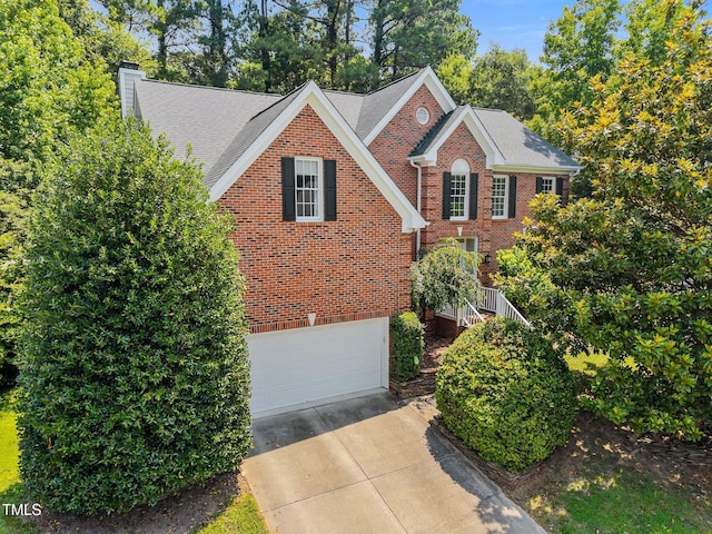 3306 Meadowrun Dr, Durham, NC 27707 - view of front of property with brick siding, concrete driveway, a chimney, a garage, and a shingled roof