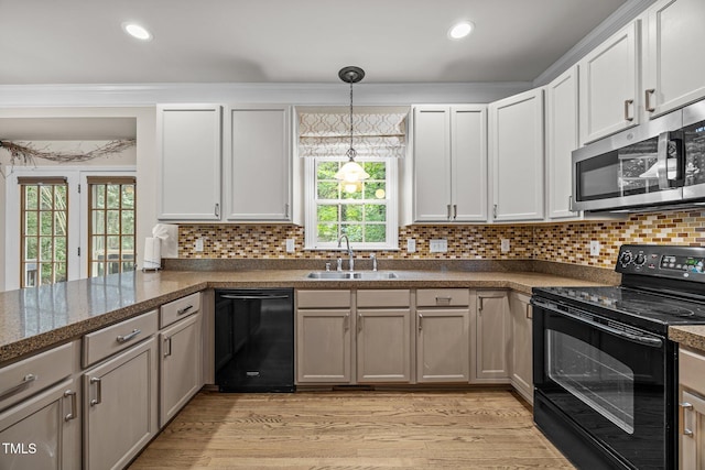 3306 Meadowrun Dr, Durham, NC 27707 - kitchen with black appliances, decorative backsplash, light wood-type flooring, pendant lighting, and recessed lighting