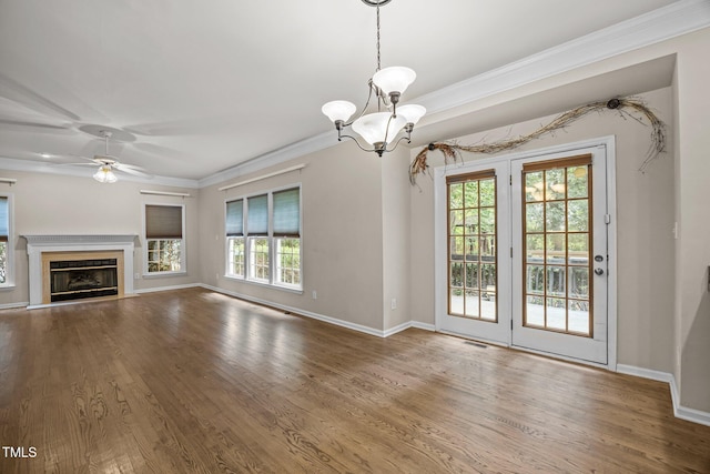3306 Meadowrun Dr, Durham, NC 27707 - unfurnished living room with ornamental molding, wood finished floors, a chandelier, ceiling fan, and a glass covered fireplace