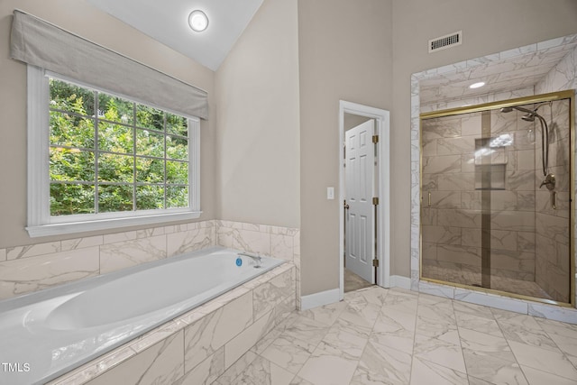3306 Meadowrun Dr, Durham, NC 27707 - full bathroom featuring marble finish flooring, a garden tub, a shower stall, and high vaulted ceiling