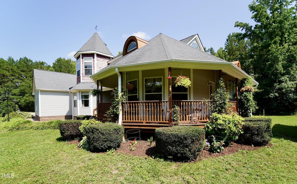 2816 Shepard School Rd, Zebulon, NC 27597 - victorian home with covered porch, a front yard, and a shingled roof
