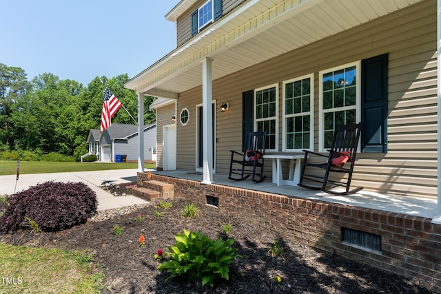 486 S Denise Ave, Coats, NC 27521 - porch featuring a garage and concrete driveway