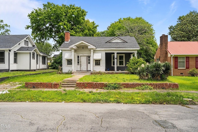 403 E Mulberry St, Goldsboro, NC 27530 - view of front of property with a front lawn and a chimney