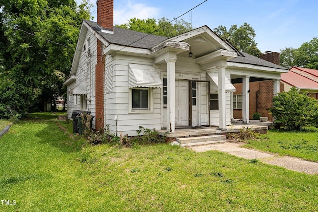 403 E Mulberry St, Goldsboro, NC 27530 - view of front of property featuring a chimney, a front lawn, and a shingled roof
