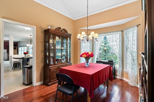 107 Canyon Run, Cary, NC 27513 - dining space with a chandelier, crown molding, baseboards, and hardwood / wood-style floors