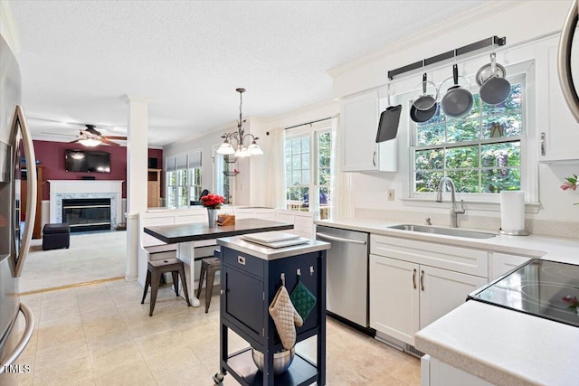 107 Canyon Run, Cary, NC 27513 - kitchen with appliances with stainless steel finishes, a sink, ceiling fan, light countertops, and white cabinets