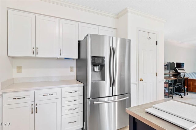 107 Canyon Run, Cary, NC 27513 - kitchen featuring stainless steel refrigerator with ice dispenser, white cabinets, crown molding, light countertops, and a textured ceiling