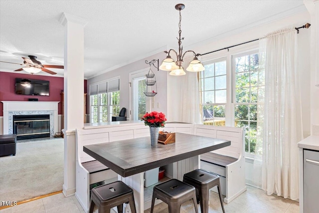 107 Canyon Run, Cary, NC 27513 - dining space with a chandelier, ceiling fan, a textured ceiling, ornamental molding, and a fireplace