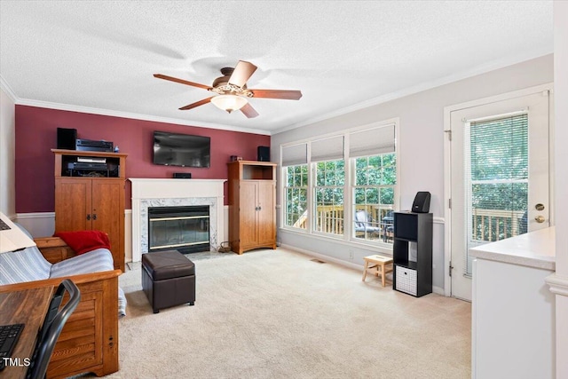 107 Canyon Run, Cary, NC 27513 - carpeted living area with ceiling fan, a fireplace, ornamental molding, and a textured ceiling