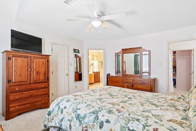 107 Canyon Run, Cary, NC 27513 - bedroom featuring light carpet, ceiling fan, a textured ceiling, and ensuite bathroom