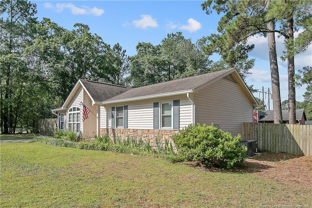 2298 Hackney Loop, Fayetteville, NC 28304 - view of property exterior with stone siding, central AC, and a shingled roof