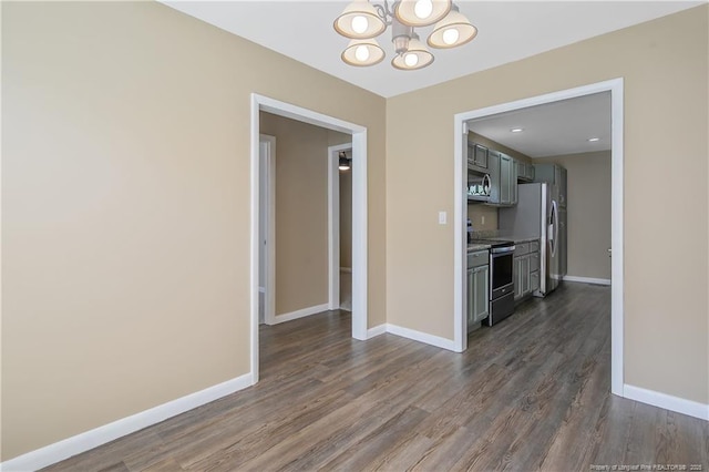 2298 Hackney Loop, Fayetteville, NC 28304 - unfurnished dining area with a chandelier, dark wood finished floors, and baseboards