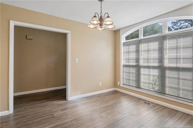 2298 Hackney Loop, Fayetteville, NC 28304 - spare room with a chandelier, wood finished floors, and baseboards