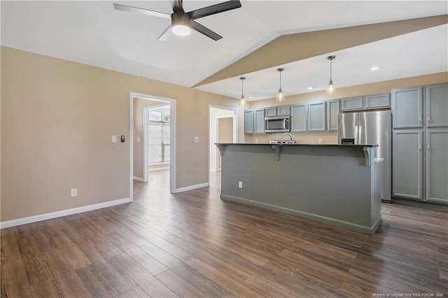 2298 Hackney Loop, Fayetteville, NC 28304 - kitchen featuring appliances with stainless steel finishes, ceiling fan, dark countertops, lofted ceiling, and baseboards