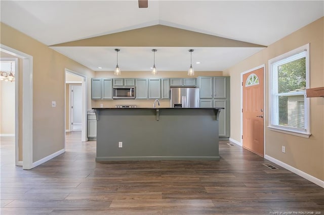 2298 Hackney Loop, Fayetteville, NC 28304 - kitchen with stainless steel appliances, dark countertops, dark wood-style floors, baseboards, and lofted ceiling