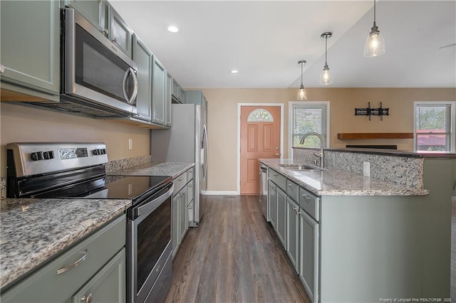 2298 Hackney Loop, Fayetteville, NC 28304 - kitchen with stainless steel appliances, a sink, gray cabinetry, dark wood-type flooring, and a kitchen island with sink