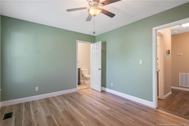2298 Hackney Loop, Fayetteville, NC 28304 - unfurnished bedroom featuring wood finished floors, baseboards, connected bathroom, and ceiling fan