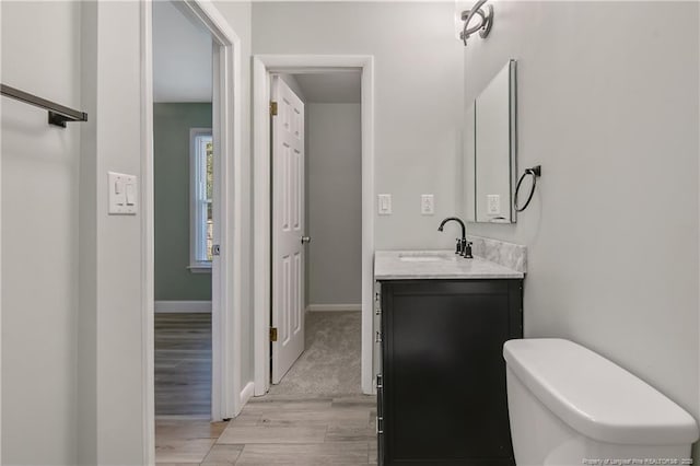 2298 Hackney Loop, Fayetteville, NC 28304 - bathroom featuring vanity, wood finished floors, baseboards, and toilet