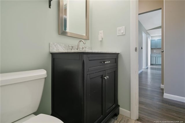 2298 Hackney Loop, Fayetteville, NC 28304 - half bath with toilet, baseboards, vanity, and wood finished floors
