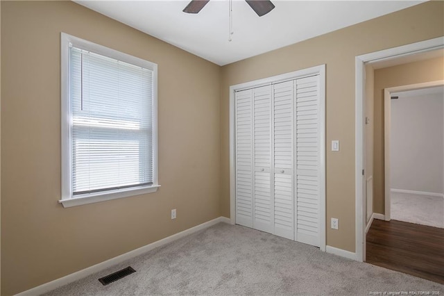 2298 Hackney Loop, Fayetteville, NC 28304 - unfurnished bedroom featuring carpet flooring, a closet, baseboards, and ceiling fan