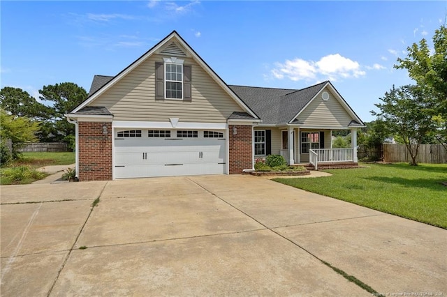 107 Hayes Ct, Raeford, NC 28376 - traditional home with a porch, concrete driveway, brick siding, and a garage
