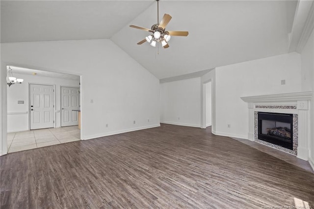 107 Hayes Ct, Raeford, NC 28376 - unfurnished living room with a ceiling fan, wood finished floors, vaulted ceiling, a tile fireplace, and a chandelier