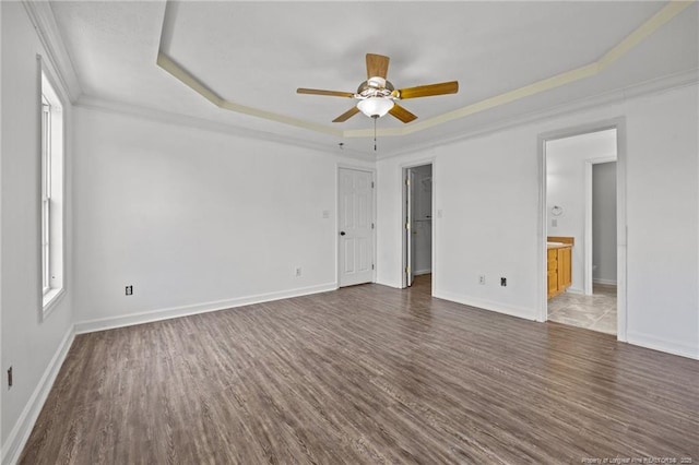 107 Hayes Ct, Raeford, NC 28376 - empty room with a raised ceiling, dark wood-style floors, a ceiling fan, baseboards, and ornamental molding