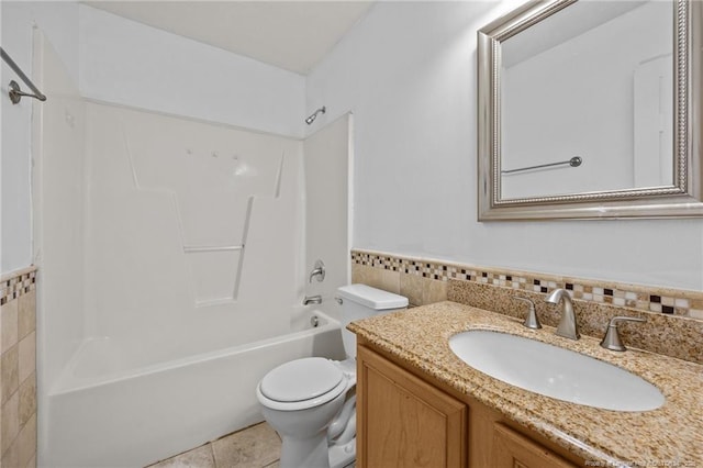 107 Hayes Ct, Raeford, NC 28376 - bathroom with toilet, vanity, tub / shower combination, tile walls, and a wainscoted wall