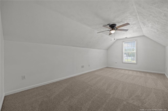 107 Hayes Ct, Raeford, NC 28376 - additional living space featuring baseboards, vaulted ceiling, light carpet, a ceiling fan, and a textured ceiling