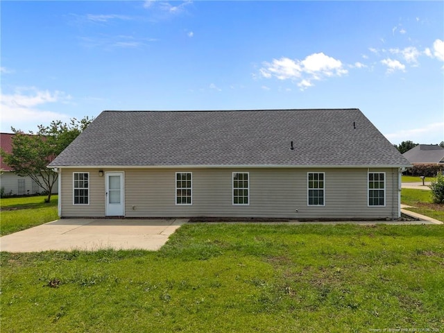 107 Hayes Ct, Raeford, NC 28376 - rear view of house featuring a patio area, a lawn, and roof with shingles