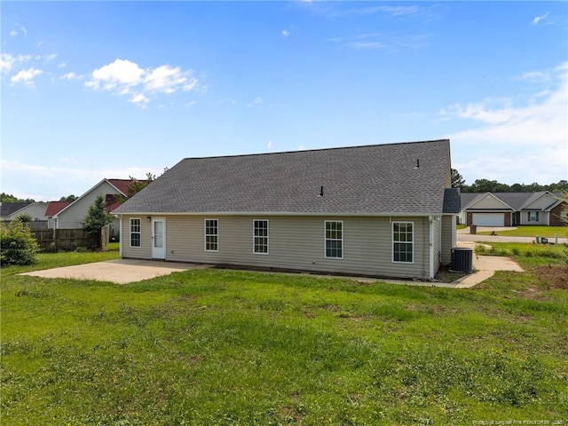 107 Hayes Ct, Raeford, NC 28376 - rear view of property featuring a patio area, a yard, roof with shingles, and central AC unit