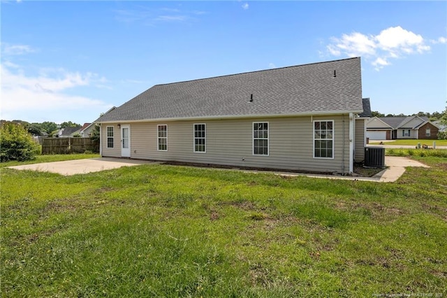 107 Hayes Ct, Raeford, NC 28376 - back of property featuring central air condition unit, a patio, and roof with shingles