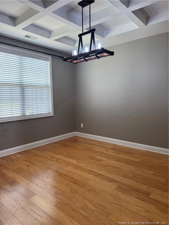 1545 Gallant Fox Ct, Parkton, NC 28371 - unfurnished room featuring coffered ceiling, a chandelier, baseboards, wood finished floors, and beam ceiling