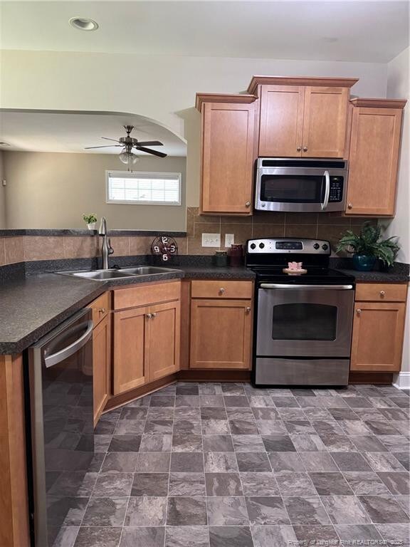1545 Gallant Fox Ct, Parkton, NC 28371 - kitchen with appliances with stainless steel finishes, a sink, and dark countertops