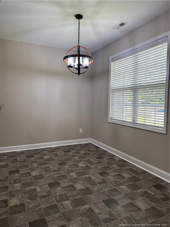 1545 Gallant Fox Ct, Parkton, NC 28371 - spare room featuring a chandelier and baseboards