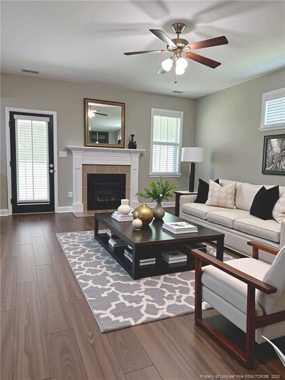 1545 Gallant Fox Ct, Parkton, NC 28371 - living room featuring dark wood finished floors, ceiling fan, baseboards, and a fireplace