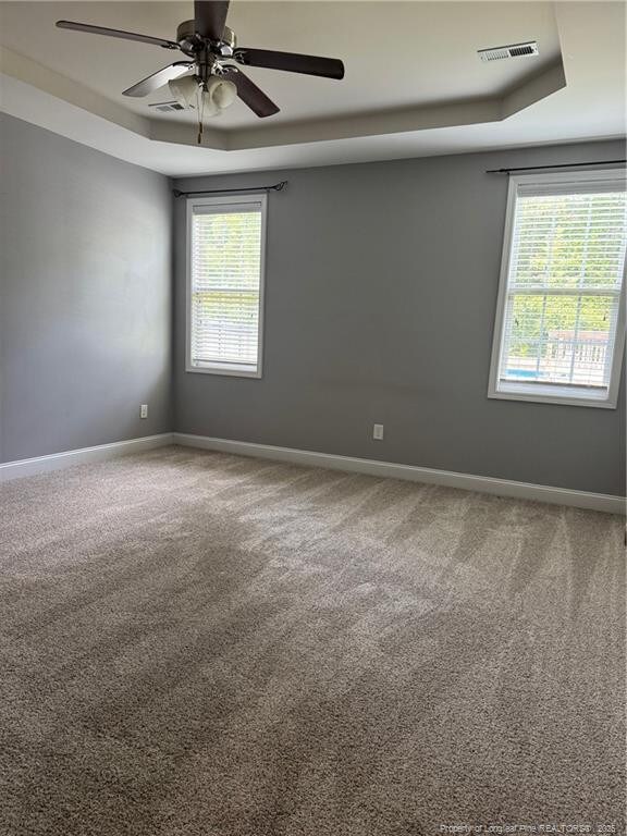 1545 Gallant Fox Ct, Parkton, NC 28371 - carpeted spare room featuring ceiling fan, baseboards, and a raised ceiling