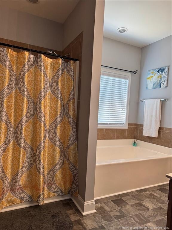 1545 Gallant Fox Ct, Parkton, NC 28371 - bathroom featuring a bath and curtained shower