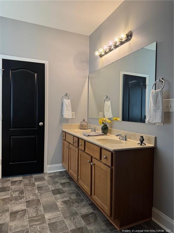 1545 Gallant Fox Ct, Parkton, NC 28371 - full bath featuring double vanity and baseboards