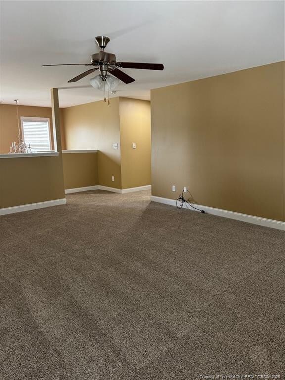 1545 Gallant Fox Ct, Parkton, NC 28371 - empty room featuring a ceiling fan, carpet floors, and baseboards