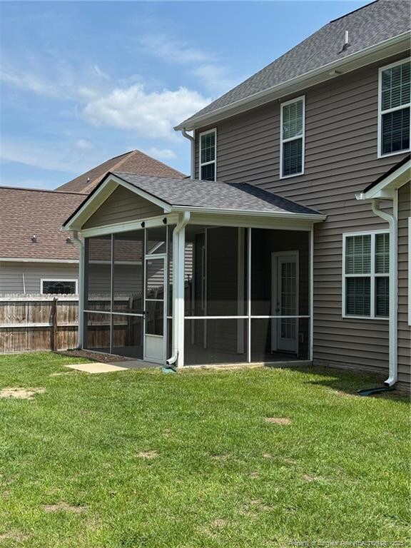 1545 Gallant Fox Ct, Parkton, NC 28371 - rear view of property featuring a sunroom and a shingled roof