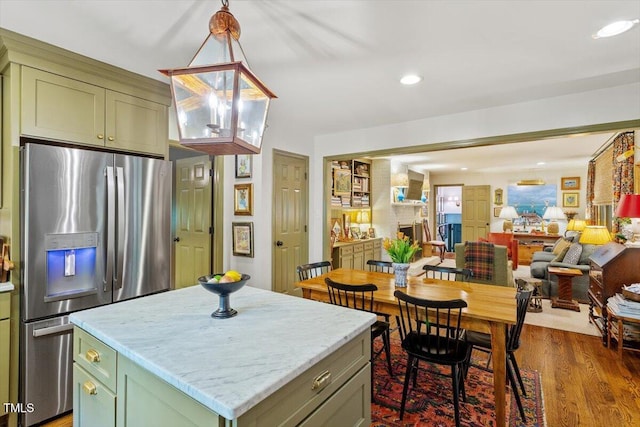 3308 Cobblestone Ct, Raleigh, NC 27607 - kitchen featuring stainless steel fridge, green cabinets, a kitchen island, dark wood-style flooring, and open floor plan