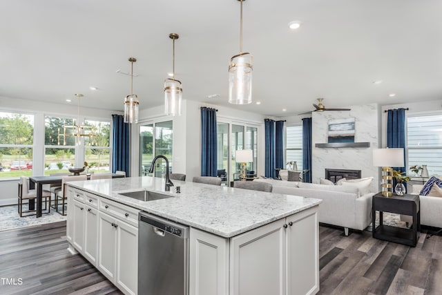 2516 Del Webb Gardens Dr, Fuquay Varina, NC 27526 - kitchen featuring a sink, stainless steel dishwasher, ceiling fan, dark wood-type flooring, and a high end fireplace