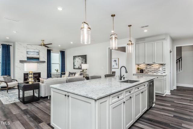 2516 Del Webb Gardens Dr, Fuquay Varina, NC 27526 - kitchen featuring a sink, dark wood-style floors, stainless steel dishwasher, white cabinetry, and recessed lighting