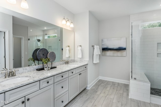 2516 Del Webb Gardens Dr, Fuquay Varina, NC 27526 - full bathroom with a stall shower, double vanity, baseboards, and recessed lighting